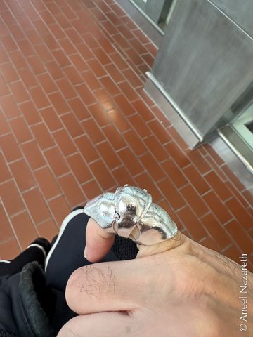 A ring meant to look like the finger of a gauntlet, with three silver plates enclosing the knuckle